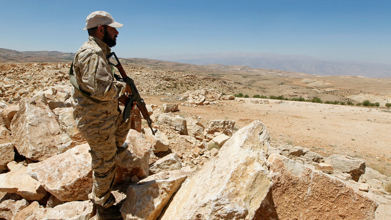 A Hezbollah fighter holds his weapon at Juroud Arsal, Syria-Lebanon border, July 25, 2017. REUTERS/Mohamed Azakir