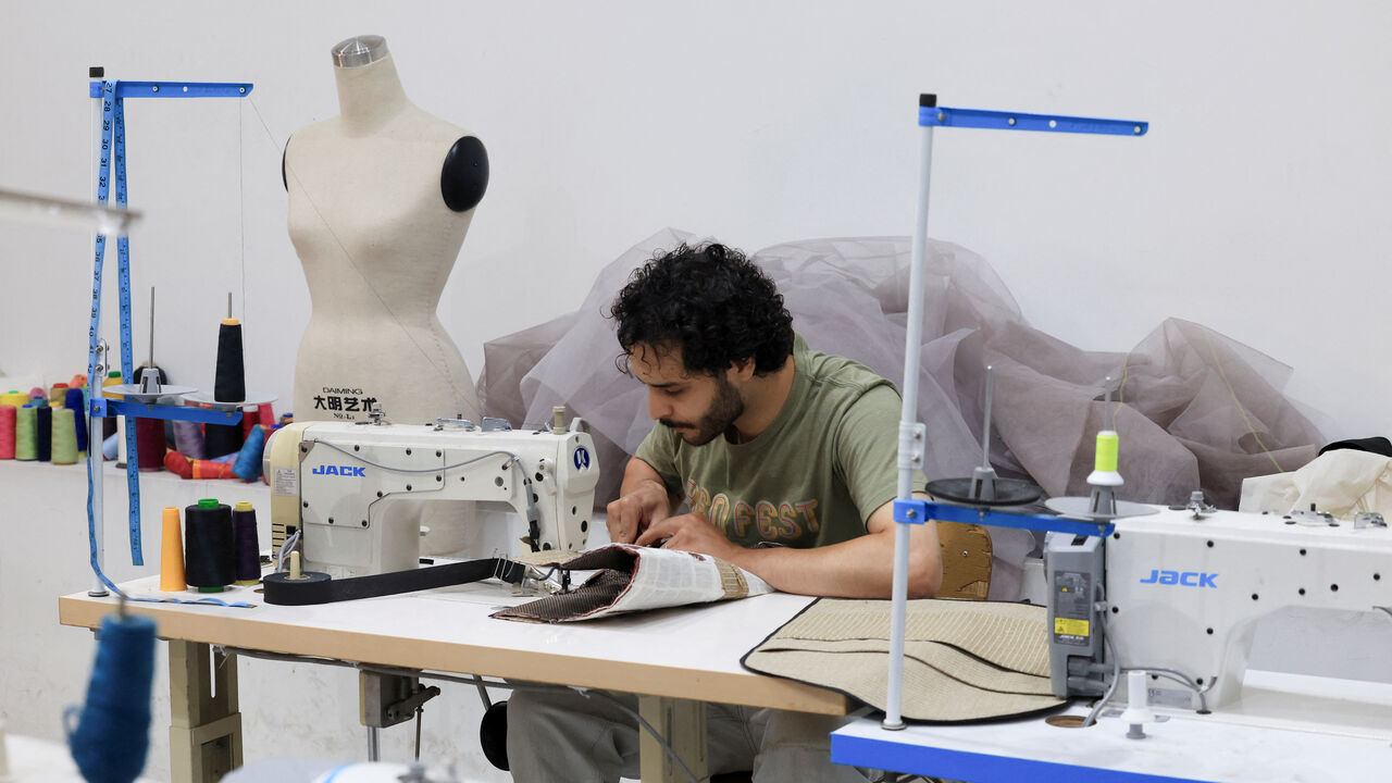 A man works on a design using a sewing machine at Creative Space Beirut, a tuition-free fashion design school in Beirut, Lebanon, July 28, 2026. REUTERS/Mohammad Azakir