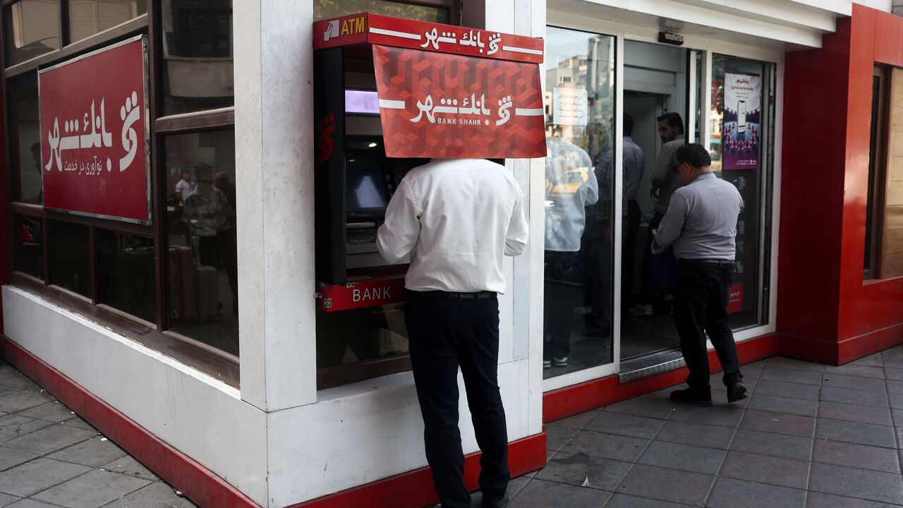 A man uses an ATM in front of a bank in Tehran, Iran, August 17, 2026. Majid Asgaripour/WANA (West Asia News Agency) via REUTERS  ATTENTION EDITORS - THIS PICTURE WAS PROVIDED BY A THIRD PARTY. ISRAEL OUT. NO COMMERCIAL OR EDITORIAL SALES IN ISRAEL. NO ACCESS FOR ISRAELI MEDIA. NO USE BBC PERSIAN. NO USE VOA PERSIAN. NO USE MANOTO. NO USE IRAN INTERNATIONAL. NO USE RADIO FARDA. DIGITAL: NO USE BBC PERSIAN. NO USE VOA PERSIAN. NO USE MANOTO. NO USE IRAN INTERNATIONAL. NO USE RADIO FARDA.