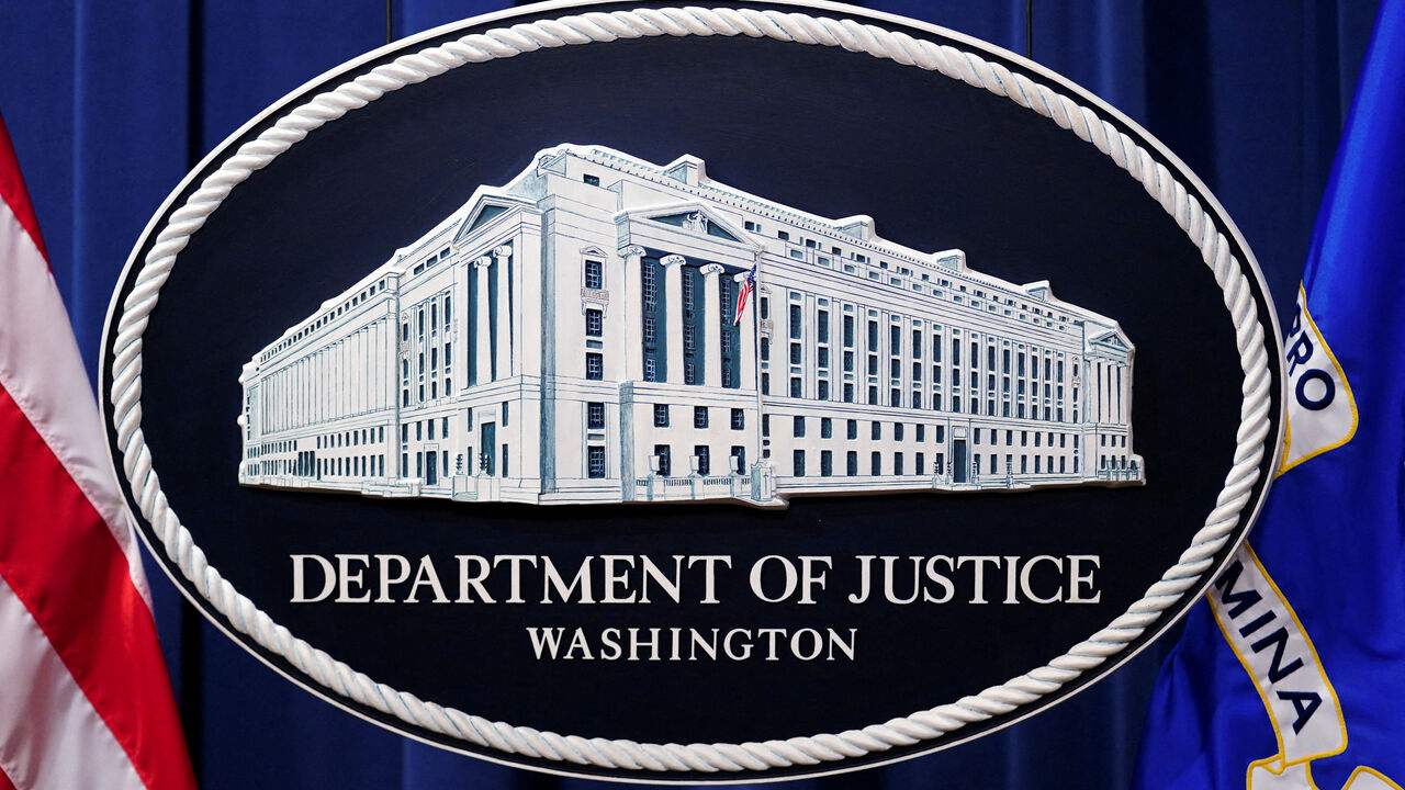 FILE PHOTO: A U.S. Justice Department logo or seal showing Justice Department headquarters, known as "Main Justice," is seen behind the podium in the Department's headquarters briefing room in Washington, January 24, 2023.  REUTERS/Kevin Lamarque/File Photo