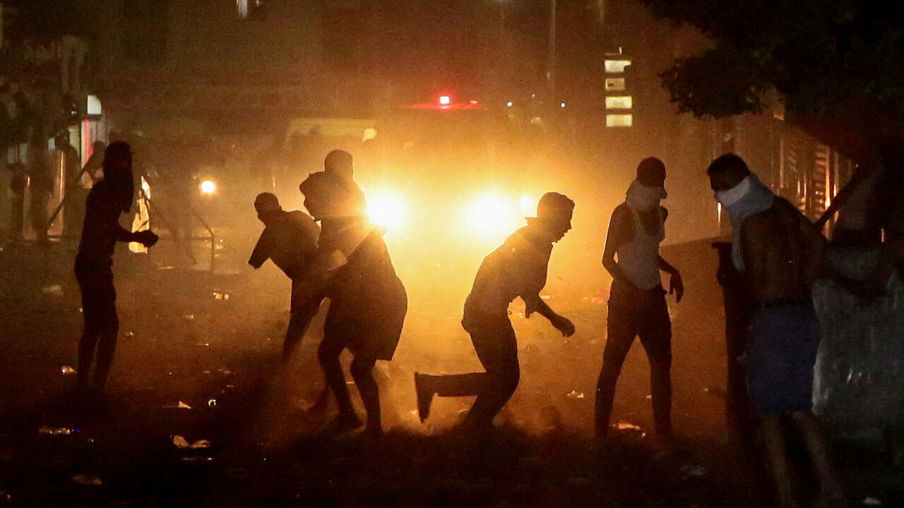 Demonstrators clash with security forces during a protest, following the sinking of a migrant boat bound for Italy, in Ben Guerdane, Tunisia, August 23, 2026. REUTERS/Ahmed Jarray