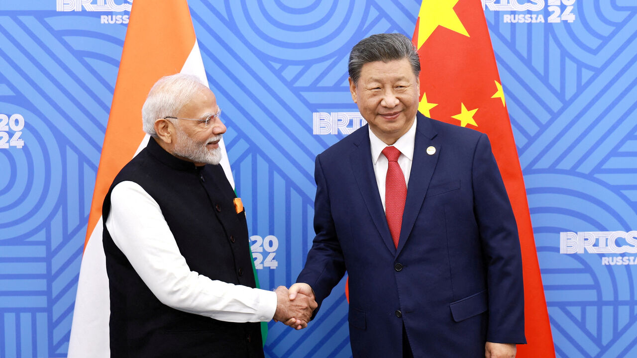 FILE PHOTO: Chinese President Xi Jinping and India Prime Minister Narendra Modi meet on the sidelines of the BRICS summit in Kazan, Russia October 23, 2024. China Daily via REUTERS