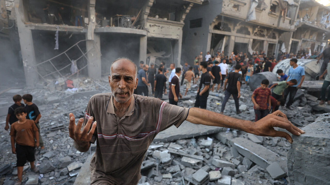 A man gestures as Palestinians inspect the site of an Israeli strike on a house, carried out after the Israeli military warned residents to evacuate the area, at al-Shati (Beach) refugee camp, in Gaza City, August 24, 2026. REUTERS/Dawoud Abu Alkas