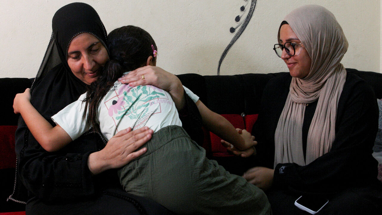 Fatma Sobhy, mother of Egyptian rape survivor Amal Abdel Hameed, who won a landmark paternity case, hugs her granddaughter at their family home in Dakahlia Governorate, in the northeast of Egypt's Nile Delta, August 17, 2026. REUTERS/Stringer