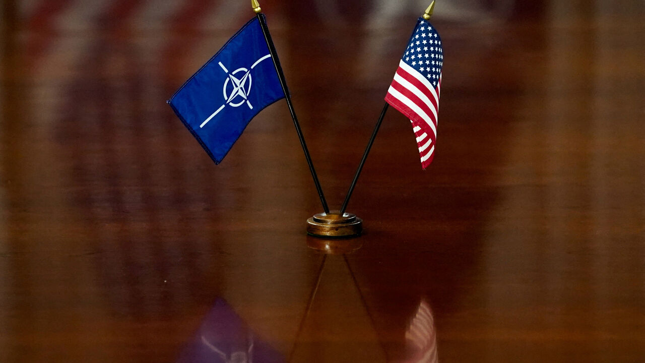 FILE PHOTO: NATO and U.S. flags are set on the table as U.S. Defense Secretary Pete Hegseth and NATO Secretary General Mark Rutte meet at the Pentagon in Washington, D.C., U.S., April 24, 2025. REUTERS/Nathan Howard/File Photo