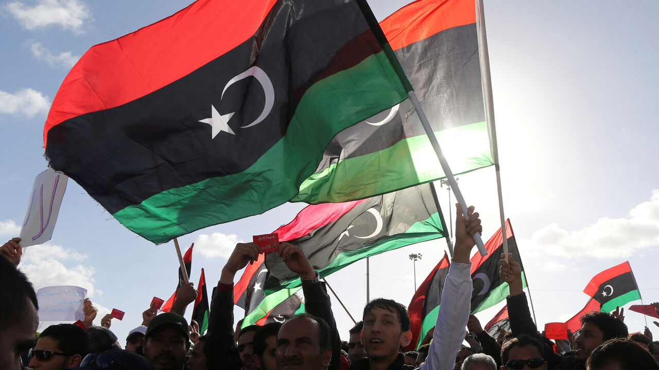 FILE PHOTO: People wave Libyan flags during a demonstration in Benghazi February 7, 2014.  REUTERS/Esam Omran Al-Fetori/File Photo