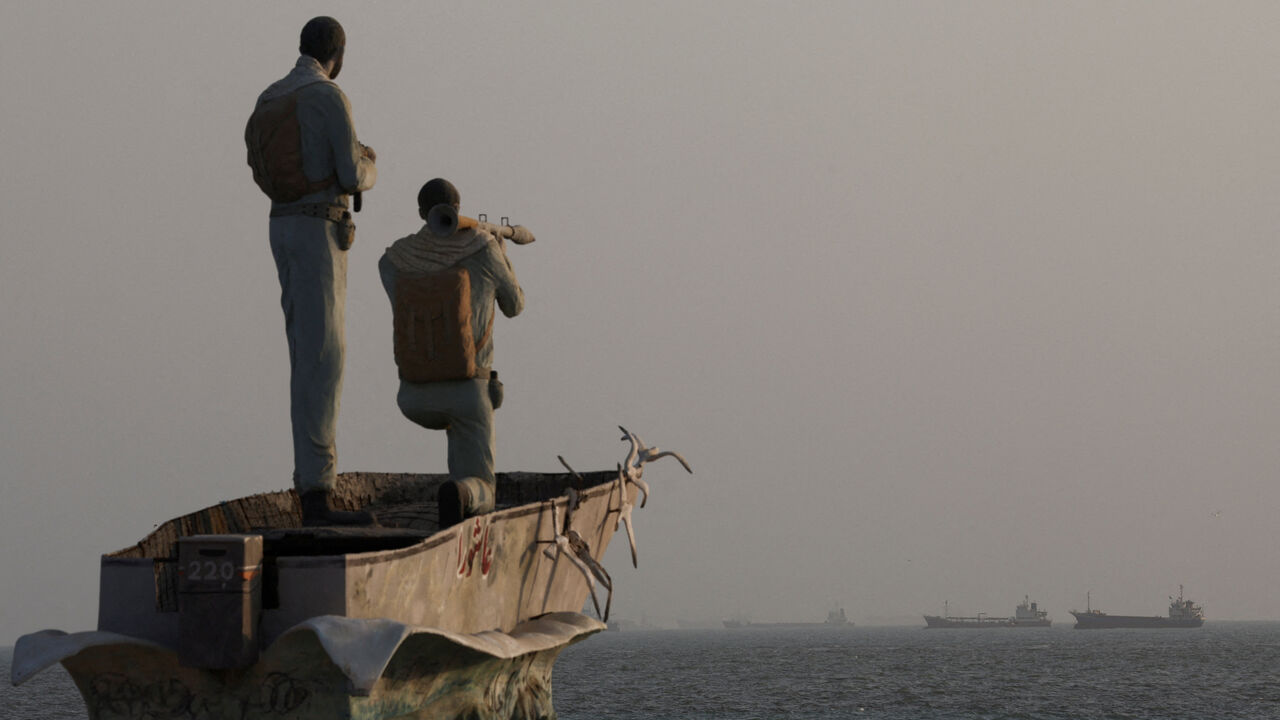 A statue of Iranian military members stands, as vessels in the Strait of Hormuz are visible near the beach of Bandar Abbas, Iran, August 26, 2026. Majid Asgaripour/WANA (West Asia News Agency) via REUTERS