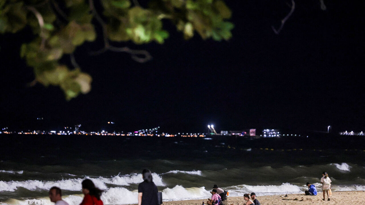People relax on the beach at Jomtien Beach, in Pattaya City, Thailand, June 29, 2026. REUTERS/Chalinee Thirasupa