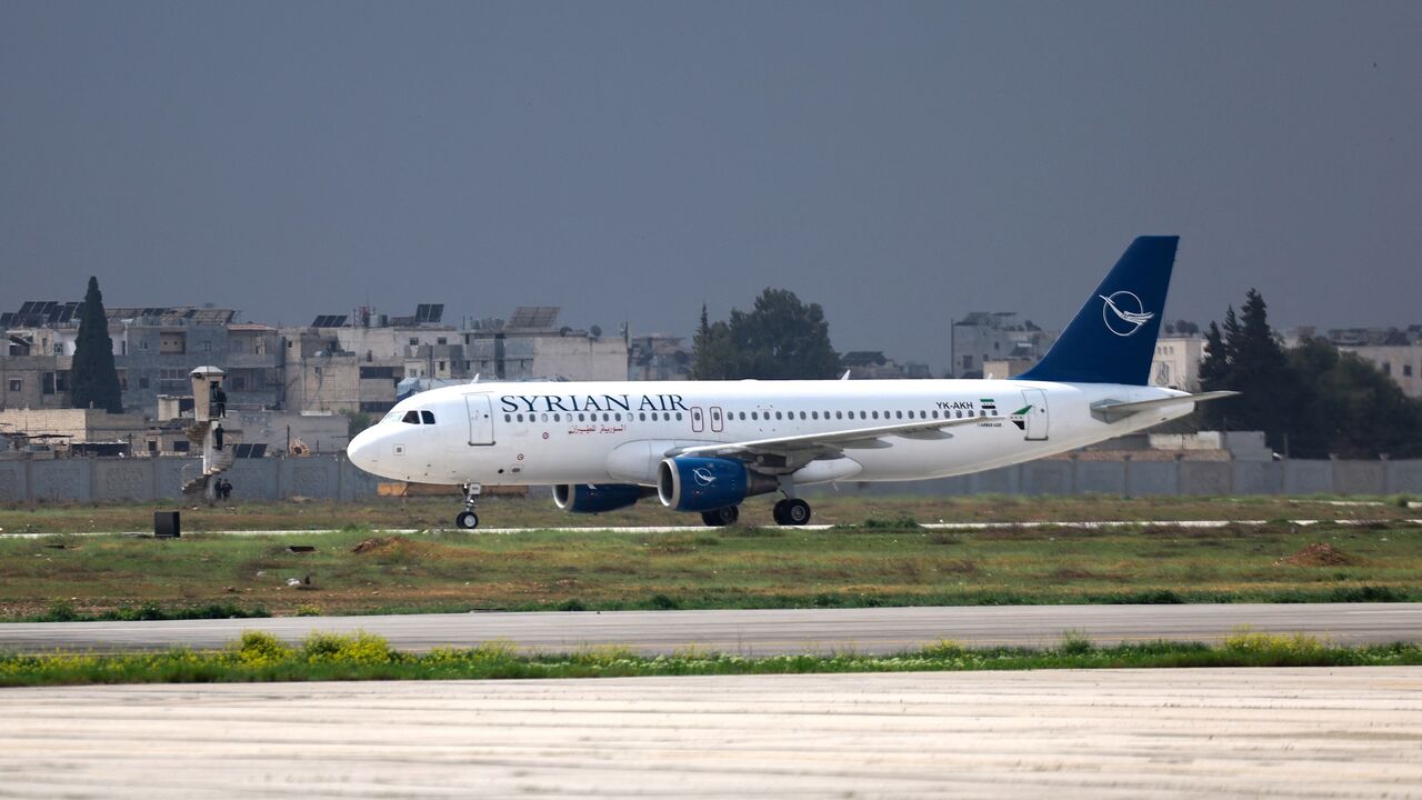 A Syrian Air passenger jet lands at Aleppo airport on March 18, 2025, the first aircraft to land after it was shut during the offensive that toppled former President Bashar al-Assad.