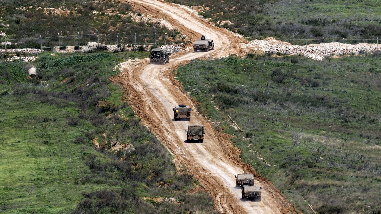 Israeli army vehicles move to a position in southern Lebanon, March 27, 2026.