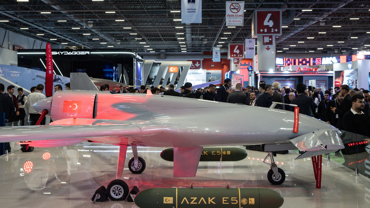People look at a drone on display at the Baykar exhibit at the SAHA International Defense and Aerospace Expo on May 6, 2026 in Istanbul, Turkey. 