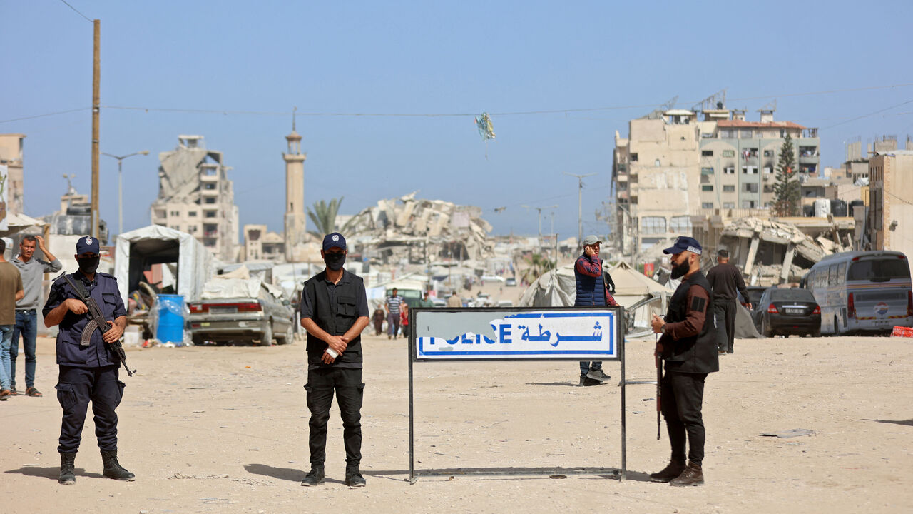 Palestinian militant group Hamas police officers stand guard as people attend the opening of the Fatah party's eighth general conference at Al-Azhar University in Gaza City on May 14, 2026. 
