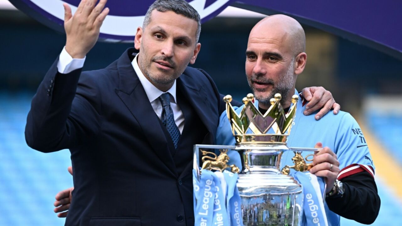 Manchester City's then-manager Pep Guardiola (R) with the club's Emirati chairman Khaldoon al-Mubarak at the presentation of the Premier League trophy in 2023