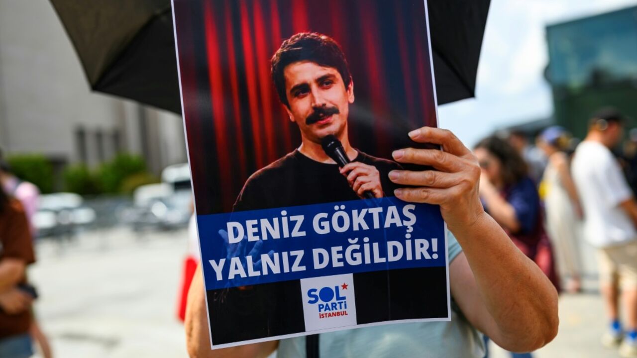 Protesters carried signs saying 'Deniz Goktas is not alone!'