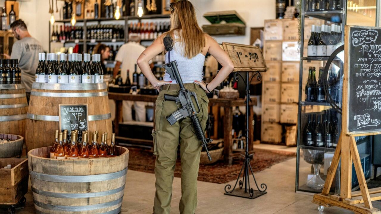 An Israeli army soldier stands at a winery in the Israeli settlement of Shaar Binyamin in the occupied West Bank