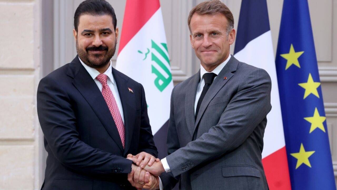 France's President Emmanuel Macron shook hands with Iraq's Prime Minister Ali al-Zaidi during the Iraqi leader's first visit to Europe since taking office in May