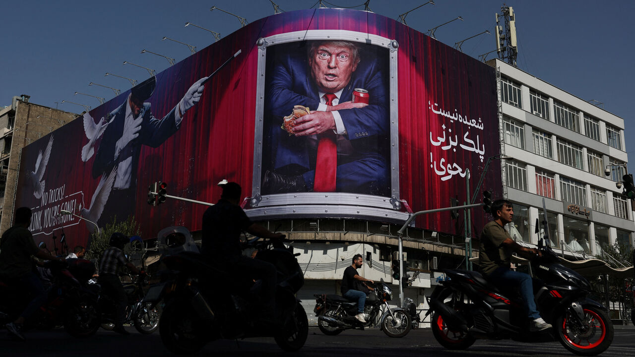 People drive near a billboard depicting U.S. President Donald Trump on a building in Tehran, Iran, September 2, 2026. Majid Asgaripour/WANA (West Asia News Agency) via REUTERS