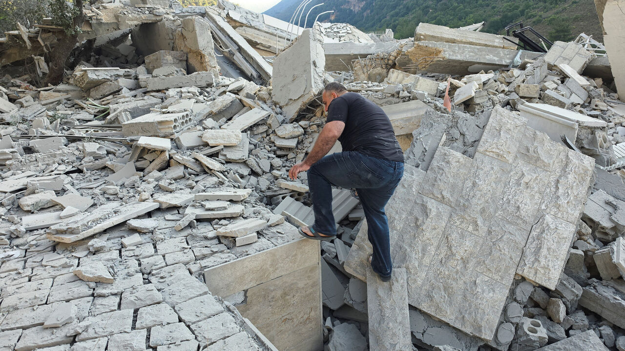 Resident Abbas Haidar makes way through rubble at the site of an Israeli strike, in Arab Salim, Lebanon, September 6 , 2026. Picture taken with a mobile phone. REUTERS/Ali Hankir