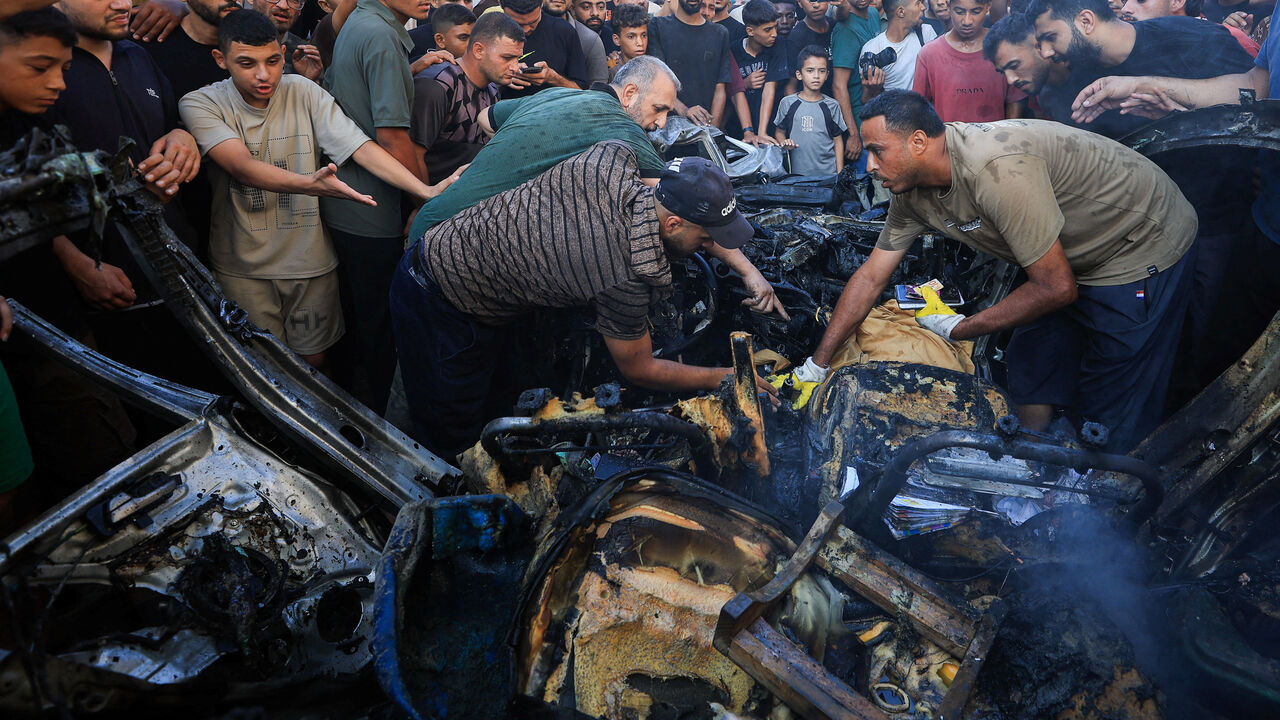 Palestinians inspect the site of an Israeli air strike on a vehicle, in Gaza City, September 6, 2026. REUTERS/Dawoud Abu Alkas