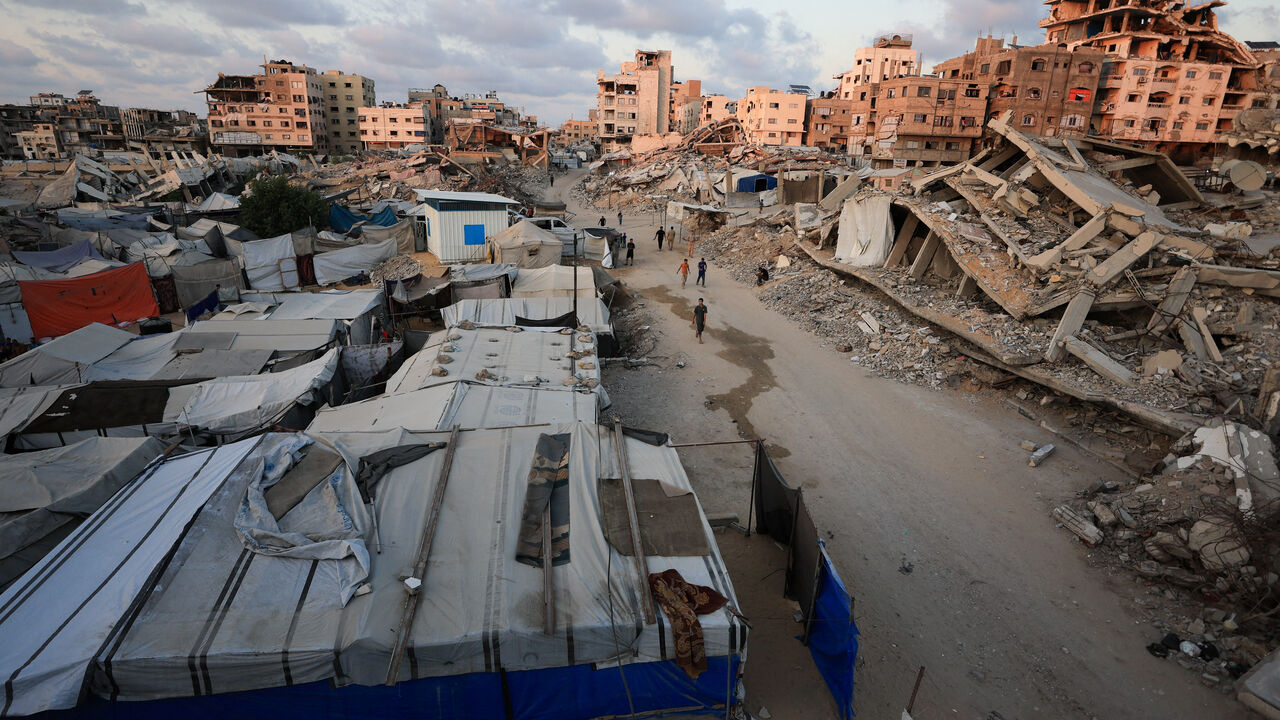 Palestinians walk past the rubble of residential buildings destroyed, in Gaza City, September 2, 2026. REUTERS/Dawoud Abu Alkas