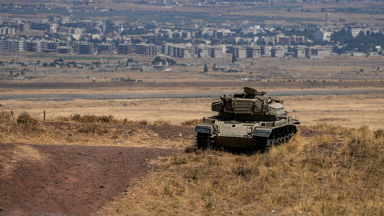 FILE PHOTO: An Israeli tank stands in position near the ceasefire line between the Israeli-occupied Golan Heights and Syria, on its Israeli side August 20, 2026. REUTERS/Ayal Margolin/File Photo
