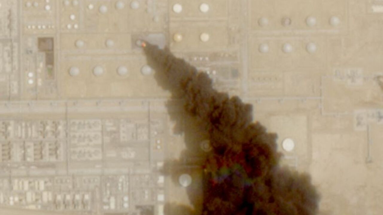 FILE PHOTO: A satellite image shows trail of smoke rising from an oil facility, in Jizan