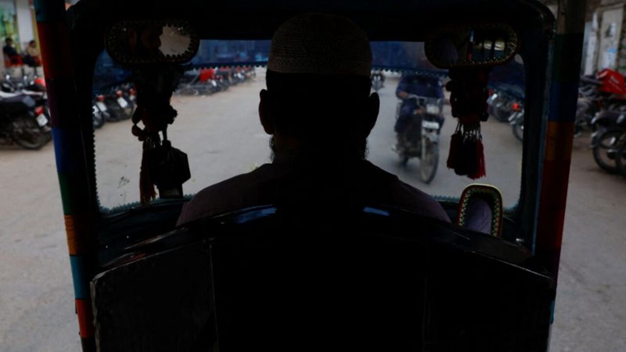 Amesh Gul, 32, a motorised auto-rickshaw driver, drives along a street amid rising fuel and liquefied petroleum gas (LPG) prices due to the Iran conflict, in Karachi