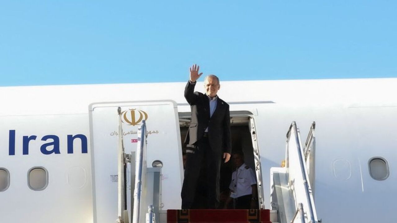 Iranian President Masoud Pezeshkian waves before departing for New York, at Mehrabad Airport in Tehran