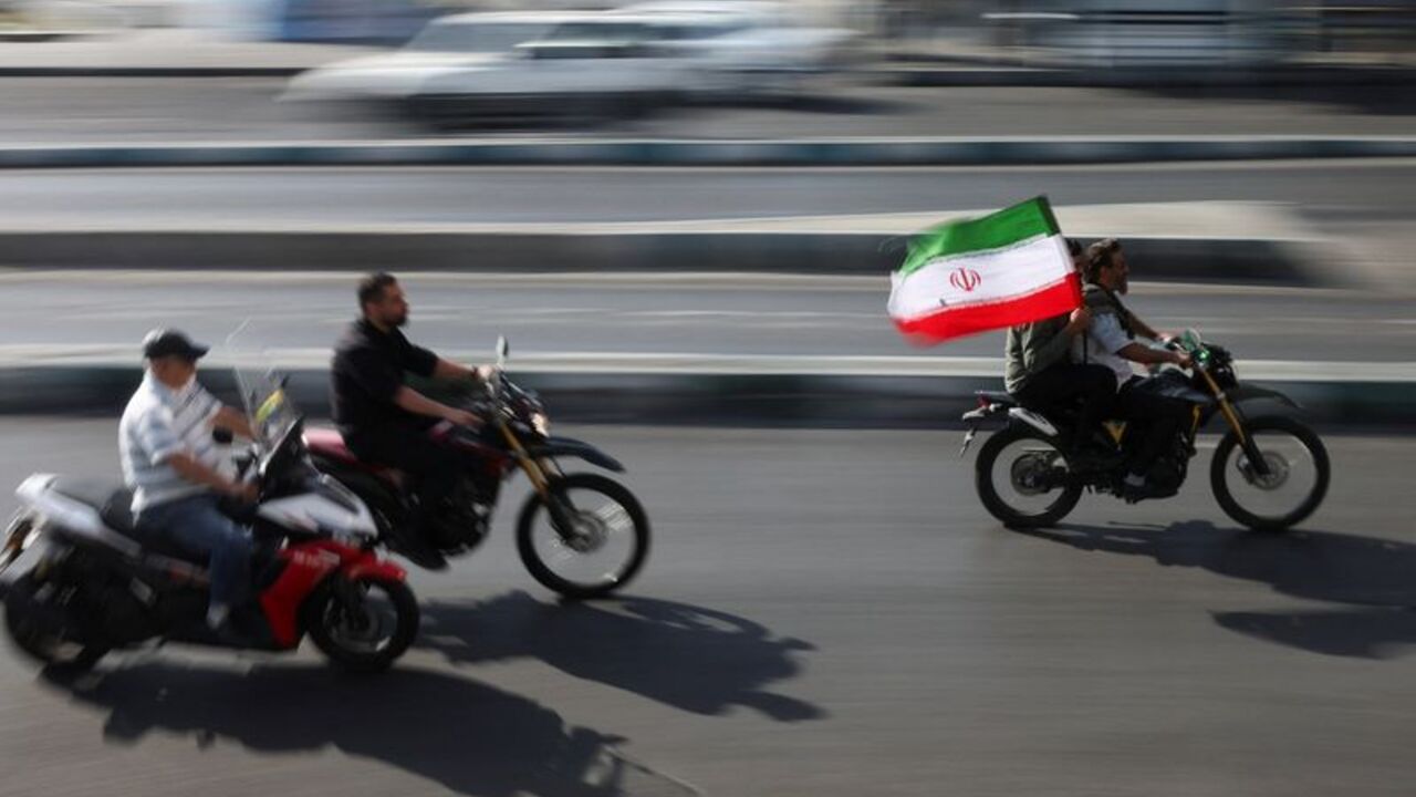 People ride on motorcycles as they participate in a march in Tehran