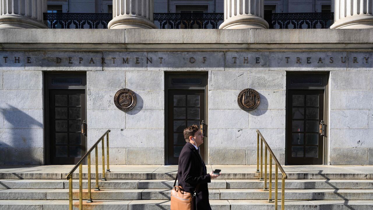 A pedestrian passes by the Treasury Building in Washington, DC on Jan. 18, 2023. 