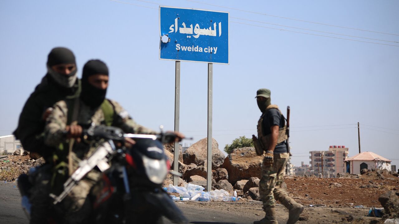 Tribal and Bedouin fighters deploy in the western neighborhood of southern Syria's predominantly Druze city of Suwayda amid clashes with Druze gunmen on July 19, 2025. 