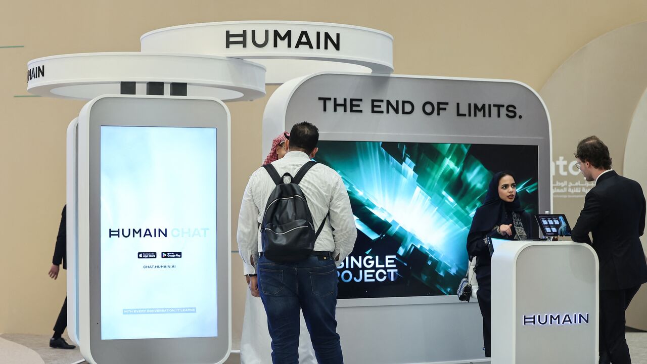 Guests stand at the booth of Saudi artificial intelligence company Humain during the Future Investment Initiative (FII) conference in Riyadh, on Oct. 29, 2025. 