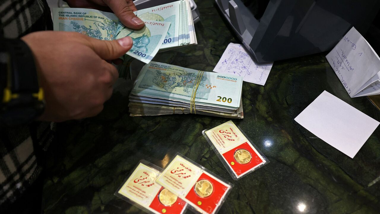 A man counts Iranian rial notes