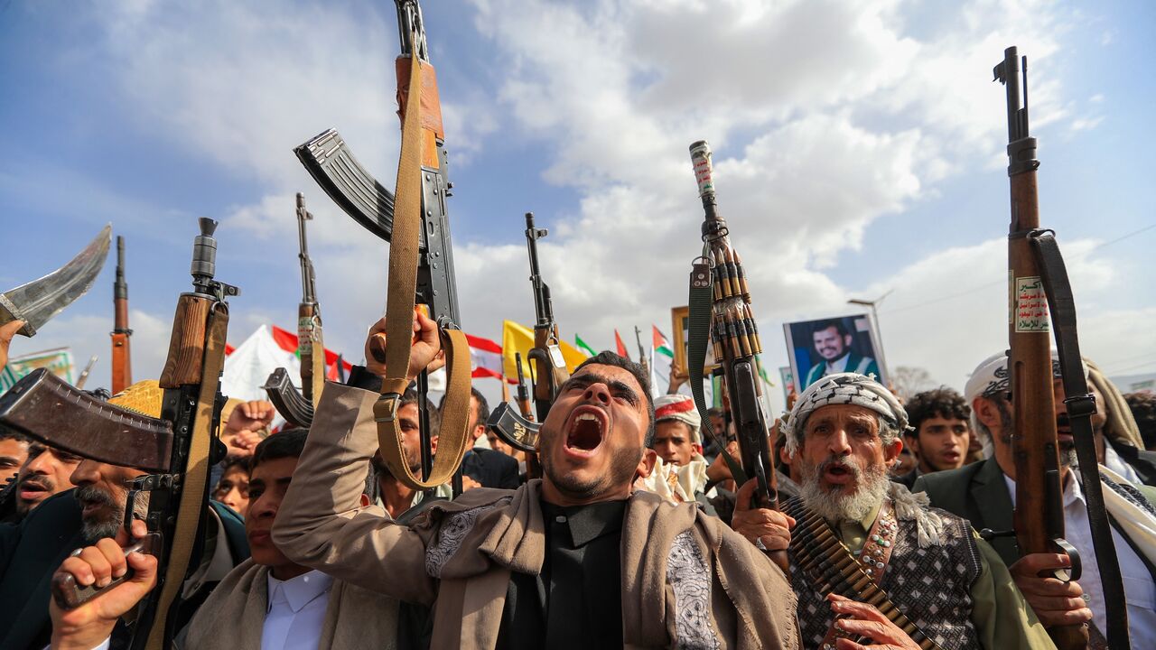 Supporters of the Iran-backed Houthi movement brandish weapons, Sanaa, July 10, 2026.