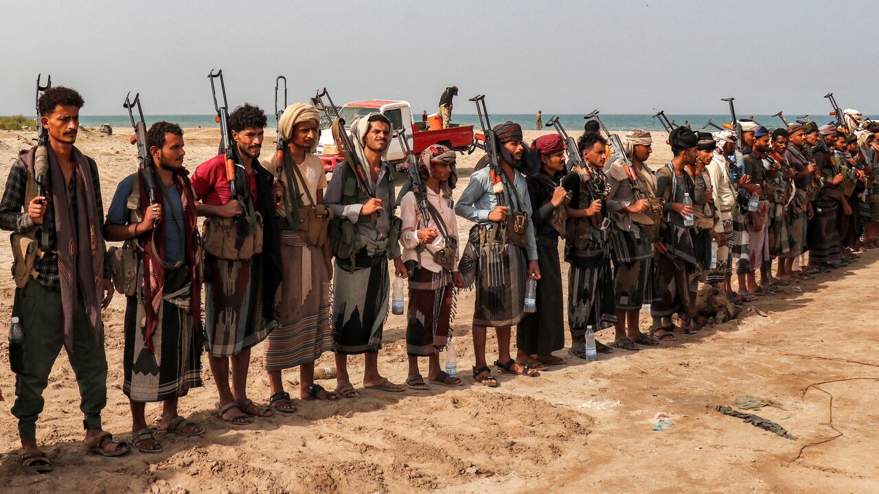 Fighters supporting the Aden-based internationally recognized Yemeni government gather during a vigil along the Red Sea shore in Khokha, in Yemen's western Hodeidah province, on July 20, 2026, calling for a resumption of hostilities with the Houthi group currently controlling the capital, Sanaa.