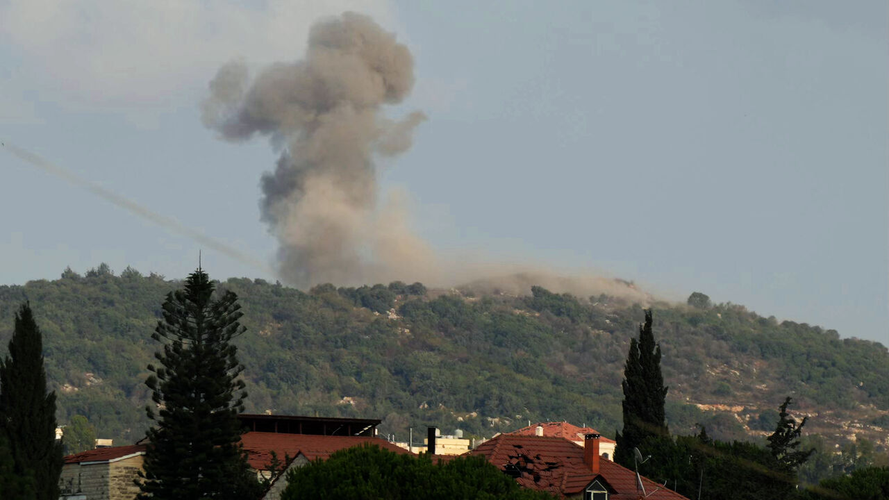 A photograph taken from the southern Lebanese area of Nabatieh shows smoke as it rises from the site of Israeli strikes that targeted the hilltops of the mountainous area of the strategic Ali al-Taher Ridge on Aug. 14, 2026.  