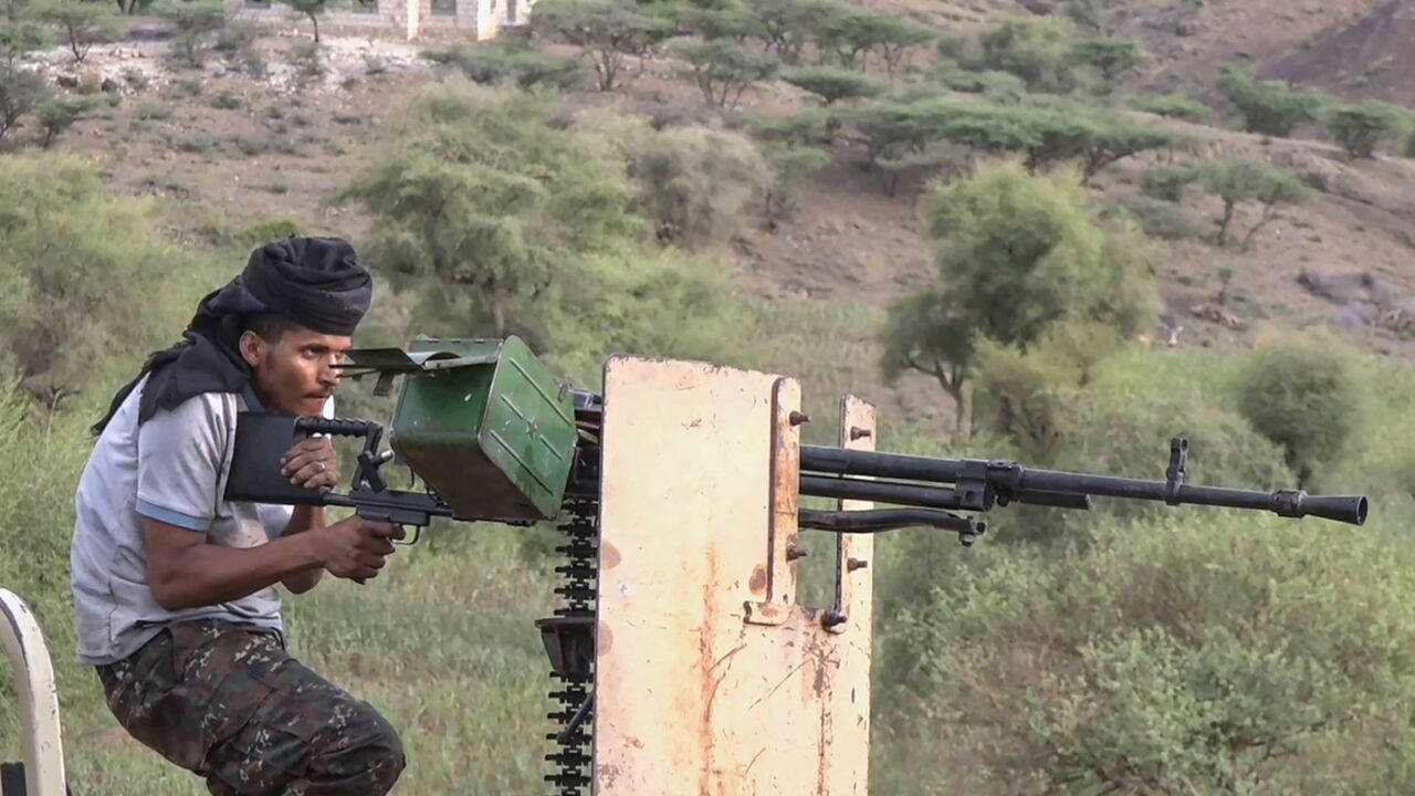 member of the Saudi-backed Yemeni government forces firing a heavy machine gun