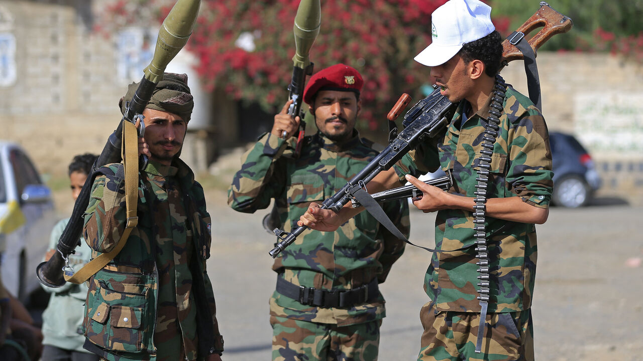 Fighters loyal to the Houthi authorities, brandish their weapons during a rally to recruit more fighters, in Sanaa on September 10, 2026. The country relapsed into war in July after years of calm, drawn into the regional conflict triggered by the US-Israeli offensive against Iran that began at the end of February. (Photo by Mohammed HUWAIS / AFP via Getty Images)
