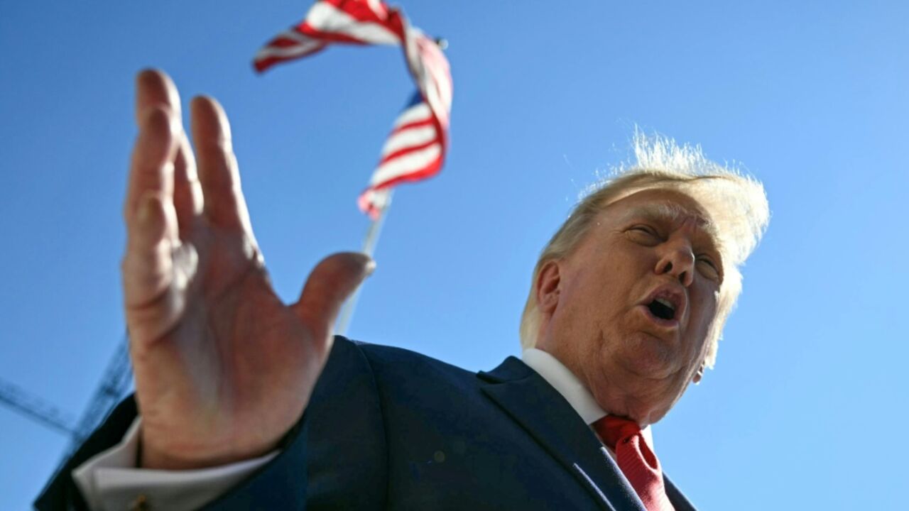 US President Donald Trump talks to members of the press before boarding Marine One from the South Lawn of the White House