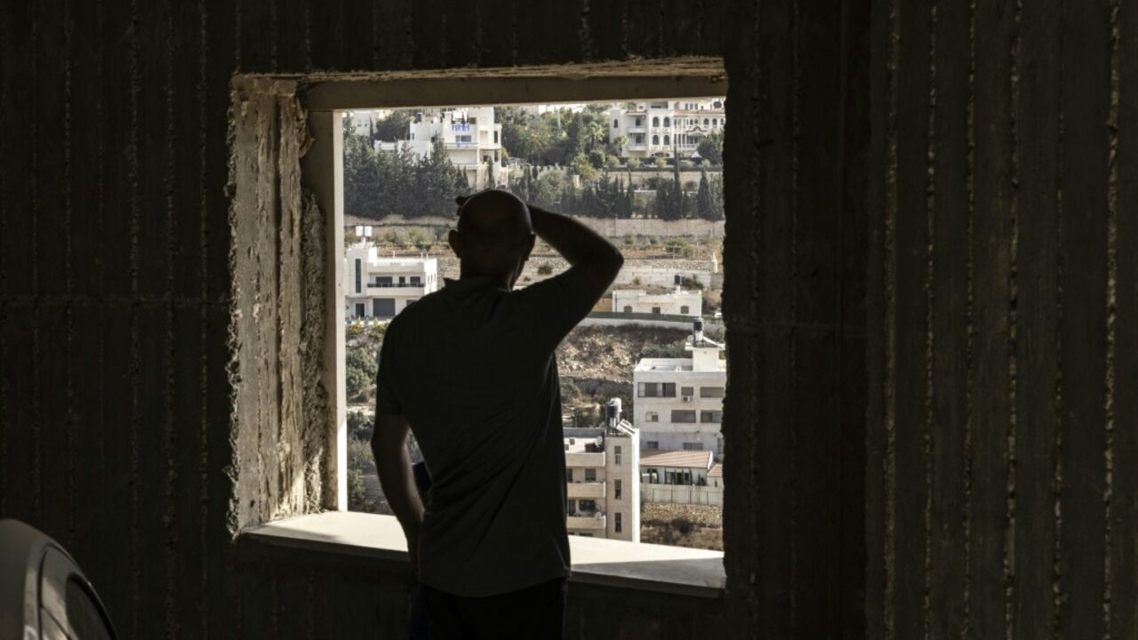 A Palestinian man looks on at empty homes after the Israeli army forces people to evacuate the Ein Deir Baha neighborhood in the occupied West Bank city of Hebron