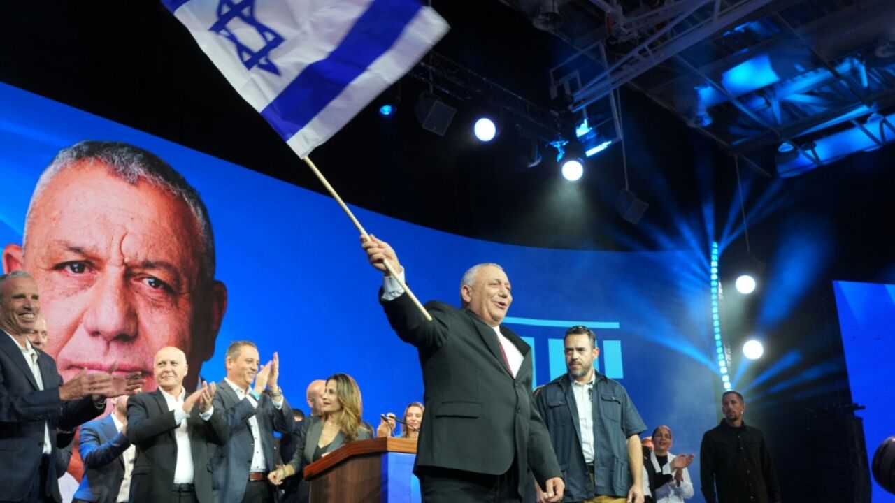 Opposition candidate Gadi Eisenkot waves Israel's national flag at an election night rally in Tel Aviv