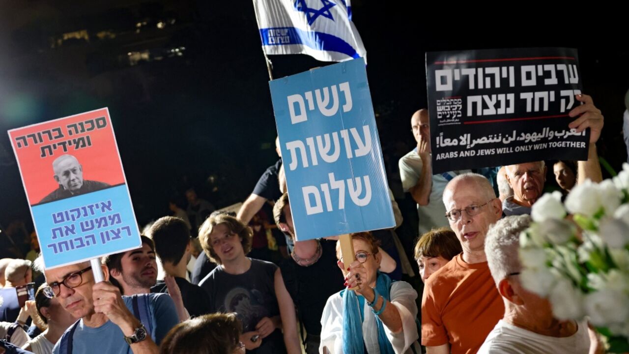 Israeli left-wing activists hold placards during a demonstration outside the home of Gadi Eisenkot, leader of the Yashar party, in Herzliya on October 29, 2026, calling for the formation of a government that includes Arab parties