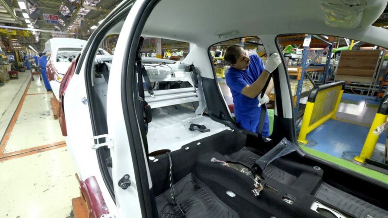 Iranian technician works at a production line of carmaker Iran Khodro, west of Tehran