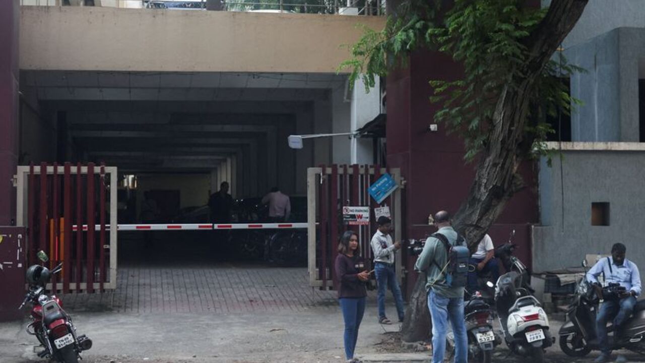 Members of the media gather outside the home of the parents of Smit Machchhar, an Indian national and a flydubai pilot who was stabbed by a colleague aboard a plane, in Mumbai