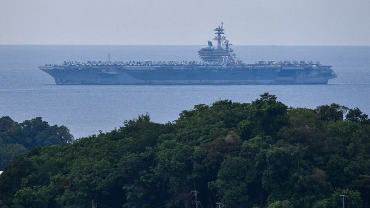 USS George H.W. Bush arrives for retreat after supporting operations in Middle East, in Phuket