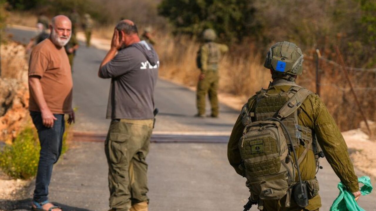 A man reacts at the scene of an incident involving an explosion, near Kiryat Shmona
