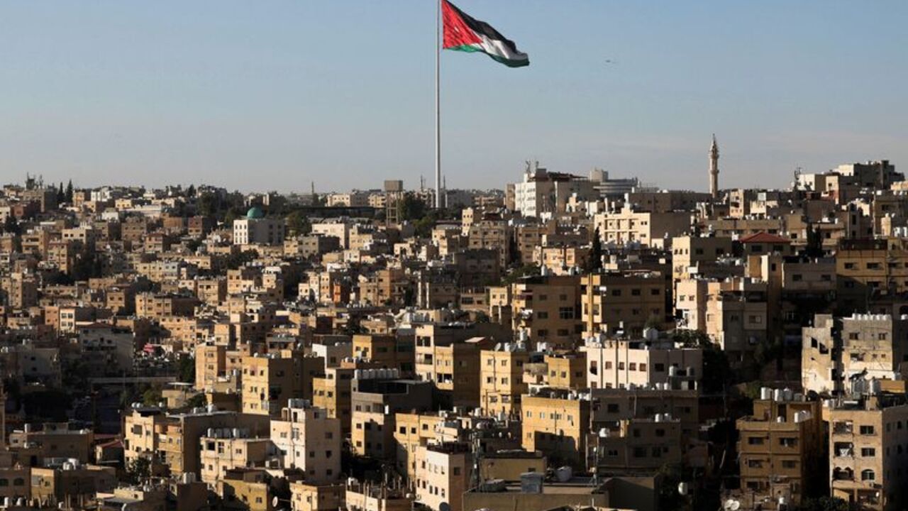 A Jordanian flag flies over the capital city, Amman