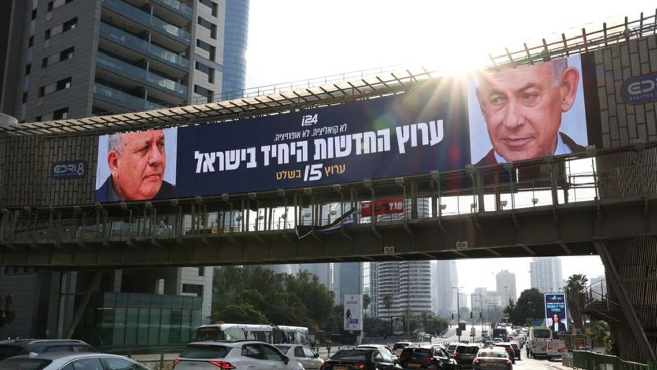 An advert for an Israeli television channel which will broadcast Israel's election, features Israeli Prime Minister Benjamin Netanyahu and former Israeli military chief Gadi Eisenkot, leader of the Yashar party, on a bridge in Tel Aviv