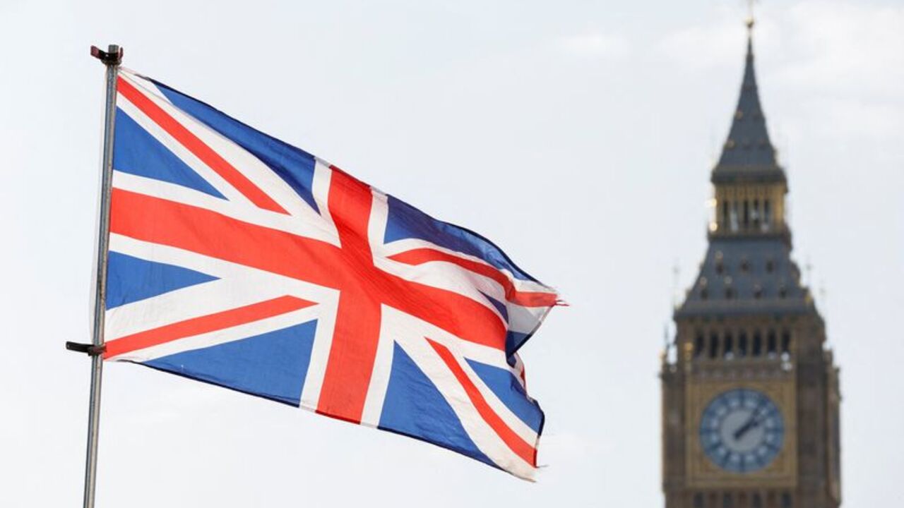 Britain's national flag flies next to the Elizabeth Tower,