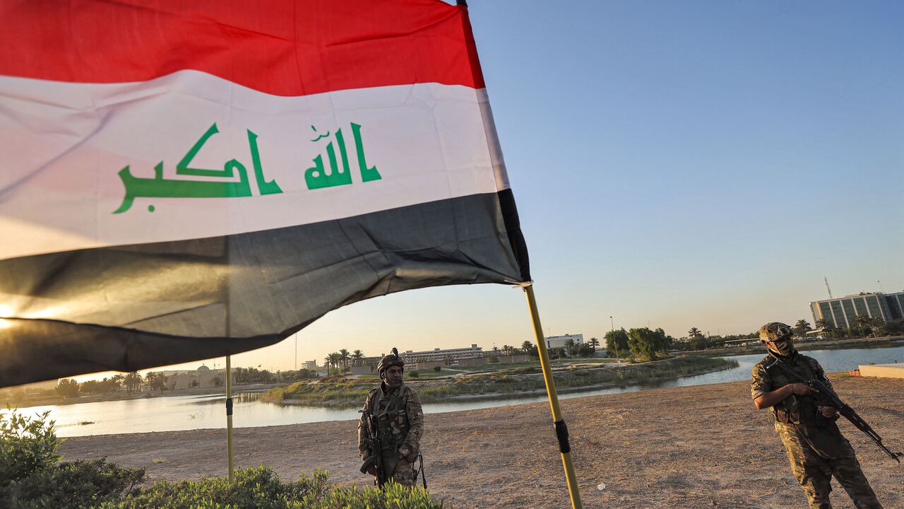 Members of Iraq's Hashed al-Shaabi (Popular Mobilization) paramilitary forces stand guard during an election rally for the "Asaib Ahl al-Haq" movement in the capital Baghdad, on October 7, 2021. 